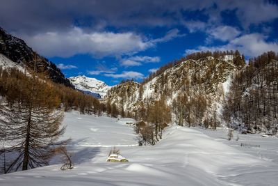 Scenic view of snow covered mountains against sky