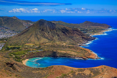 Scenic view of sea and mountains against sky