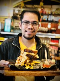 Portrait of a smiling young man in restaurant