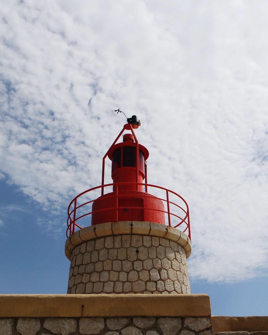 LOW ANGLE VIEW OF LIGHTHOUSE AGAINST CLOUDS