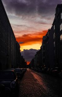 Cars on road against sky during sunset
