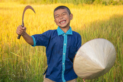 Happy boy standing on field