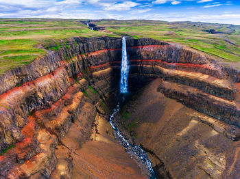 Scenic view of waterfall against landscape