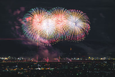 Low angle view of firework display at night