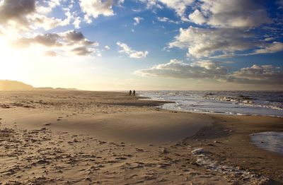 Scenic view of beach against sky during sunset