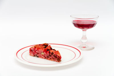 Red ice cream in plate against white background