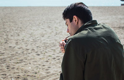 Rear view of man standing on beach