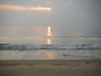 Scenic view of beach against sky during sunset