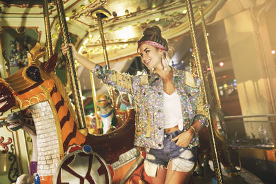 Low angle view of woman standing in amusement park