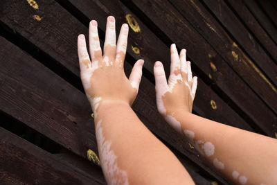 High angle view of hands on table