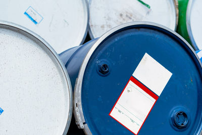 Selective focus on old chemical barrels. blue oil drum. steel oil tank. toxic waste warehouse. 