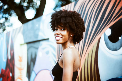 Portrait of smiling young woman standing outdoors