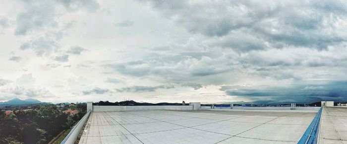 Panoramic view of airport runway against sky