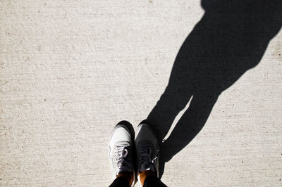 Low section of person standing on road