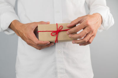 Midsection of woman holding paper in box