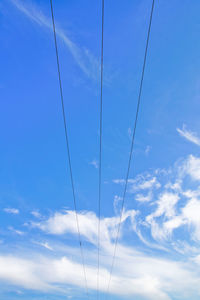 Low angle view of cable against blue sky