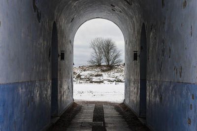 View of empty footpath in tunnel