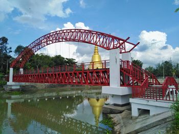 Arch bridge over river against sky