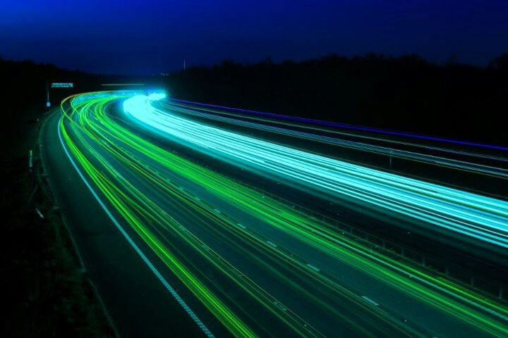 illuminated, night, light trail, long exposure, speed, motion, blurred motion, multi colored, road, transportation, light - natural phenomenon, lighting equipment, glowing, sky, outdoors, blue, street, no people, light painting, highway