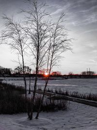 Scenic view of frozen lake against sky during winter