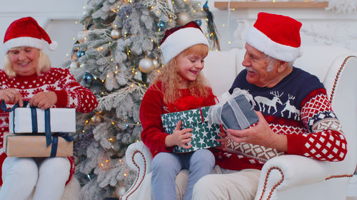 Grandparents giving gift to granddaughter