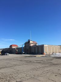 Buildings against clear blue sky