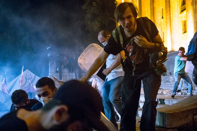 Rear view of people enjoying music concert at night