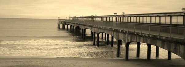 Pier on sea at sunset