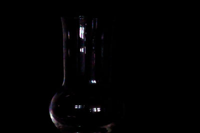 Close-up of wine glass against black background