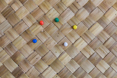 Full frame shot of wicker with colorful thumbtacks