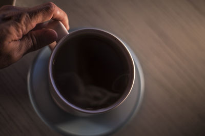 Directly above shot of person holding coffee cup