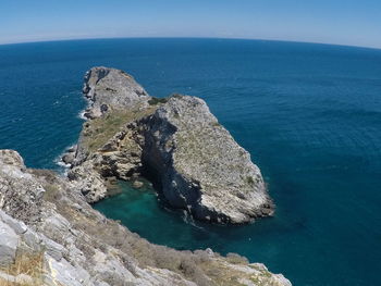 High angle view of rocks in sea against sky