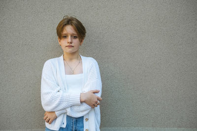 The intense gaze of a teenage redhead with short hair tells a story of youthful dreams