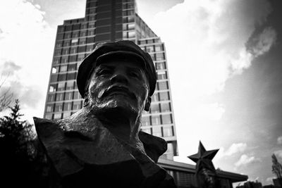 Low angle view of statue against buildings in city