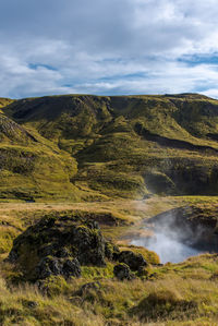 Scenic view of landscape against cloudy sky