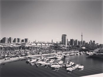 Boats in river with cityscape in background