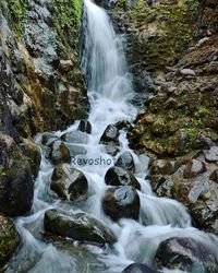 Stream flowing through rocks in forest