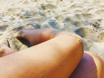 Low section of woman standing on tiled floor