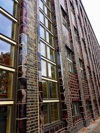 Low angle view of office building against sky