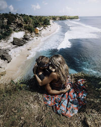 High angle view of woman on rock at beach