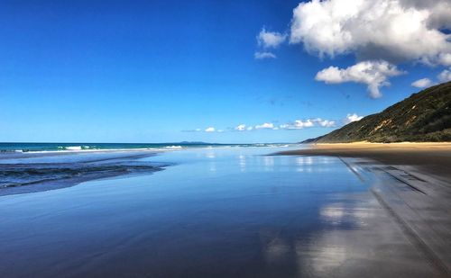 Scenic view of sea against blue sky