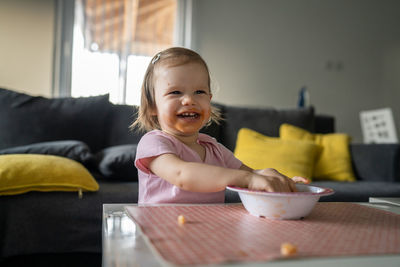 Portrait of cute boy eating food at home