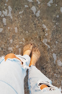 Low section of woman staying in water