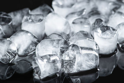 Ice cubes on a black reflective background