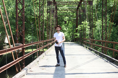 Portrait of man standing on bridge