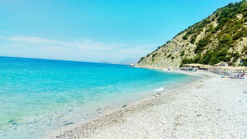 Scenic view of beach against blue sky