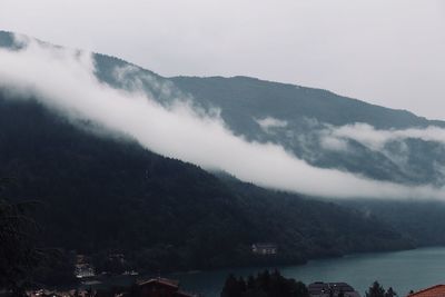 Scenic view of mountains by sea against sky