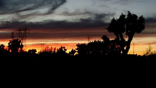 Silhouette of landscape against cloudy sky