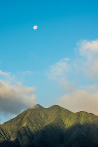 Scenic view of mountains against blue sky