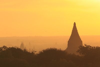 Silhouette of temple against sky during sunset